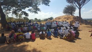 men and women attending church outdoors
