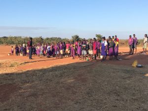 children lined up to play soccer in a field